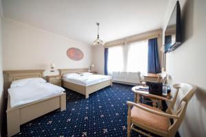 Ένα ή περισσότερα κρεβάτια σε δωμάτιο στο Hotel U Kata