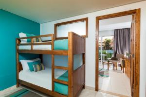 a bedroom with bunk beds and a living room at AQI Skanes Resort in Monastir