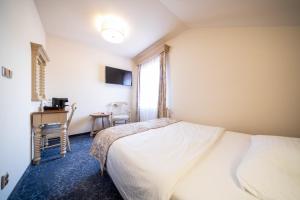 Ένα ή περισσότερα κρεβάτια σε δωμάτιο στο Hotel U Kata