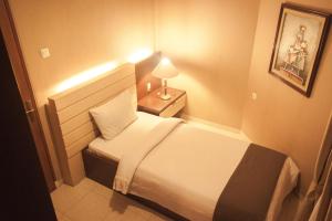 Postel nebo postele na pokoji v ubytování Travellers Suites Serviced Apartments
