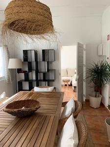 a living room with a wooden table and a couch at Dunes House in Carvalhal