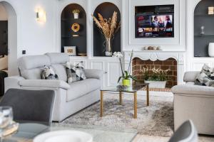 a living room with two couches and a fireplace at Ocean Vistas 24 in Puerto de la Cruz