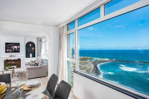 a dining room with a view of the ocean at Ocean Vistas 24 in Puerto de la Cruz