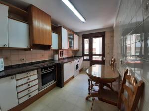 a kitchen with a table and a dining room at Arriondas Toyos A in Arriondas
