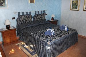 a bedroom with a bed with a bag on it at B&B Il Cantico in Greccio
