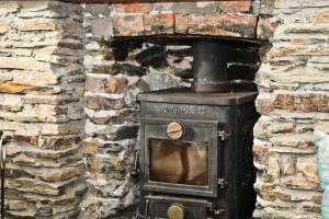 an old wood stove in a brick wall at Idyllic Cottage near Padstow in Little Petherick