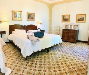 a bedroom with a bed and a table in a room at Le Relais Notre Dame in Quinson