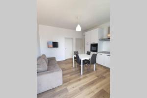 a living room with a couch and a table at DELTA D Piazza Marina- 50 MT dal mare - Immobil Relax in Lido di Jesolo +1 photo