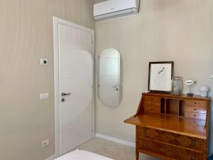 a bathroom with a shower and a wooden dresser at Villa Luminosa in Torre del Lago Puccini