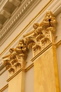 a gold column on the side of a building at Grand Hotel Casselbergh in Bruges