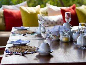 a table with plates and wine glasses on it at Nedile Lodge in Welgevonden Game Reserve