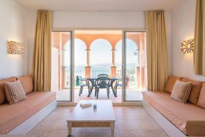 a living room with a couch and a table at Pierre & Vacances Resort Terrazas Costa del Sol in Manilva