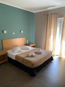 a hotel room with a bed and a desk at Alkistis Hotel in Diakopto