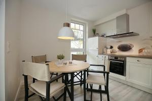 a kitchen with a table and chairs in a kitchen at Strandvilla Scholle - Dorsch Wohnung 02 in Boltenhagen