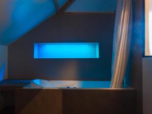 a window in a room with a blue wall at Laiterie de Tocqueville in Tocqueville +12 photos