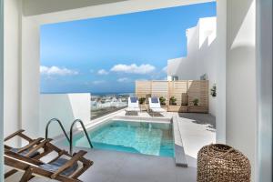 a balcony with a swimming pool and two chairs at Santo Bloom Luxury Villas in Vóthon