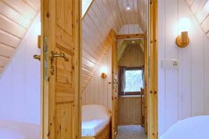 a small room with a bed and a door at An der Steilküste Finnhütte 05 in Boltenhagen