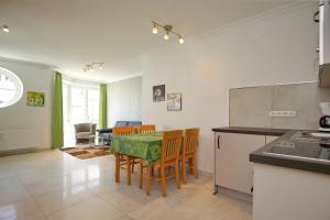 a kitchen and dining room with a table and chairs at Dünenblick Wohnung 27 in Boltenhagen