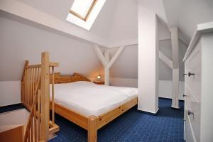 a bedroom with a wooden bed and a staircase at Villa Triton Wohnung 05 in Boltenhagen