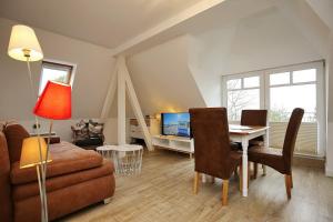 a living room with a couch and a table at Villa Triton Wohnung 05 in Boltenhagen