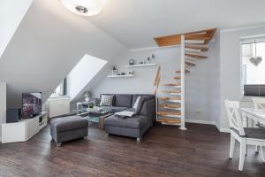 a living room with a couch and a table at Sünnslag Wohnung 060 in Boltenhagen