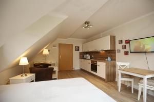 a kitchen and living room with a table and a dining room at Strandvilla Krabbe Wohnung 10 in Boltenhagen