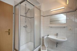 a bathroom with a shower and a sink and a toilet at Strandvilla Krabbe Wohnung 11 in Boltenhagen