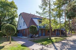 a house with a blue and white at Papillon Wohnung 18-6 in Boltenhagen