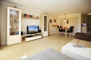a living room with a television and a table at Papillon Wohnung 15-2 in Boltenhagen