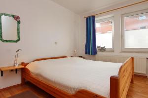 a bedroom with a large bed and a window at Goosbrink Wohnung 14 in Boltenhagen