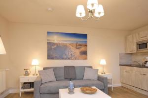 a living room with a couch and a table at Strandvilla Krabbe Wohnung 03 in Boltenhagen