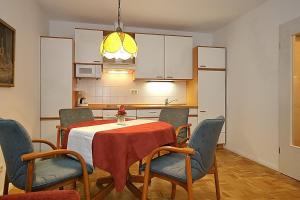 a kitchen and dining room with a table and chairs at Haffblick Wohnung 01 in Boltenhagen