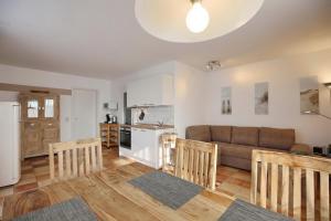 a living room with a couch and a kitchen at Dünenblick Wohnung 13 in Boltenhagen