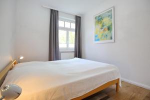 En eller flere senge i et værelse på Villa Triton Wohnung 04