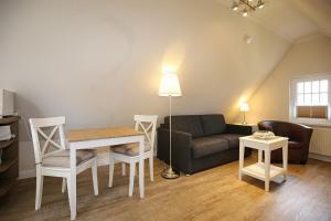 a living room with a couch and a table at Strandvilla Krabbe Wohnung 07 in Boltenhagen