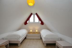 Кровать или кровати в номере Reethaus Am Mariannenweg 12b