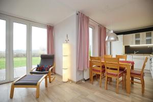 a kitchen and dining room with a table and chairs at Sünnslag Wohnung 122 in Boltenhagen