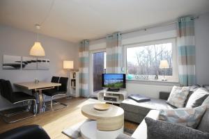 a living room with a couch and a table at Urlauberdorf Haus 41d in Boltenhagen