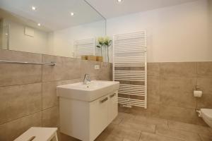 a bathroom with a sink and a toilet at Residenz von Flotow Wohnung 04 in Heiligendamm +17 photos