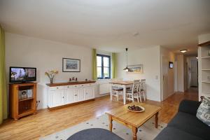 a living room with a couch and a table at Papillon Wohnung 04-4 in Boltenhagen