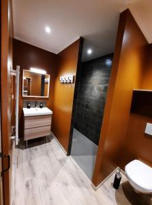 a bathroom with a white toilet and a sink at Maison Errientania in Souraïde