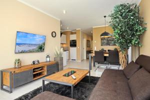 a living room with a couch and a table at Haus am Wald Wohnung Sommer in Wittenbeck