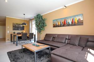 a living room with a couch and a table at Haus am Wald Wohnung Sommer in Wittenbeck