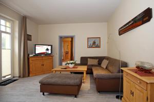 a living room with a couch and a table at La Mer Wohnung 06 in Kühlungsborn