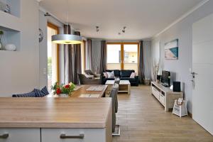 a living room with a table and a couch at Villa Sanddorn Wohnung 16 in Börgerende-Rethwisch