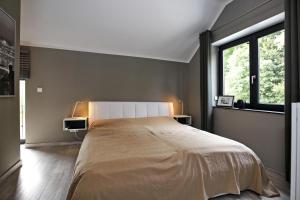 a bedroom with a large bed and a window at Haus Wittenbeck Skorpion in Wittenbeck