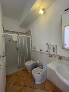 a bathroom with a toilet and a sink at Suite De Pasquale Lipari in Lipari +7 photos