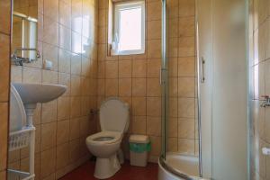 a bathroom with a toilet and a sink and a shower at Leśna Oaza in Sasino +210 photos