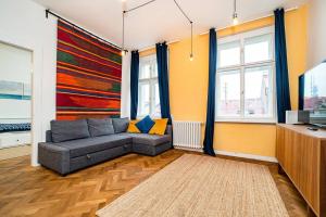 a living room with a couch and a tv at Elegant, modern, 2-bed flat by Museum of Prague in Prague