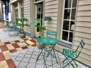 ein Tisch und Stühle vor einem Gebäude in der Unterkunft Be Cottage Hotel in Le Touquet-Paris-Plage